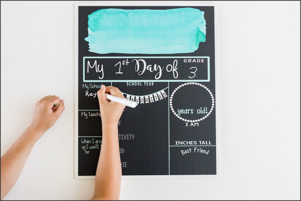 Writing on a first day of school fill-in-the-blank board