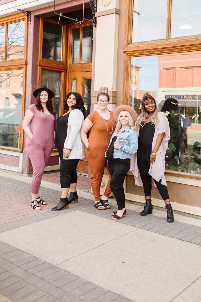 Group of models standing outside The Sill & Soil in Lethbridge, AB wearing 4Fold Threads rompers
