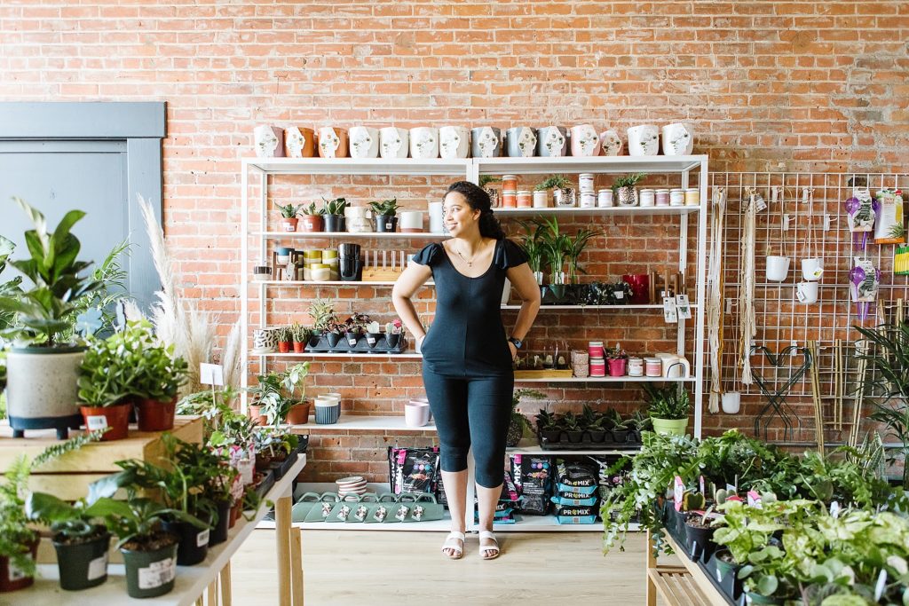 Model in 4Fold Threads black romper standing in The Sill & Soil plant store in Lethbridge Alberta