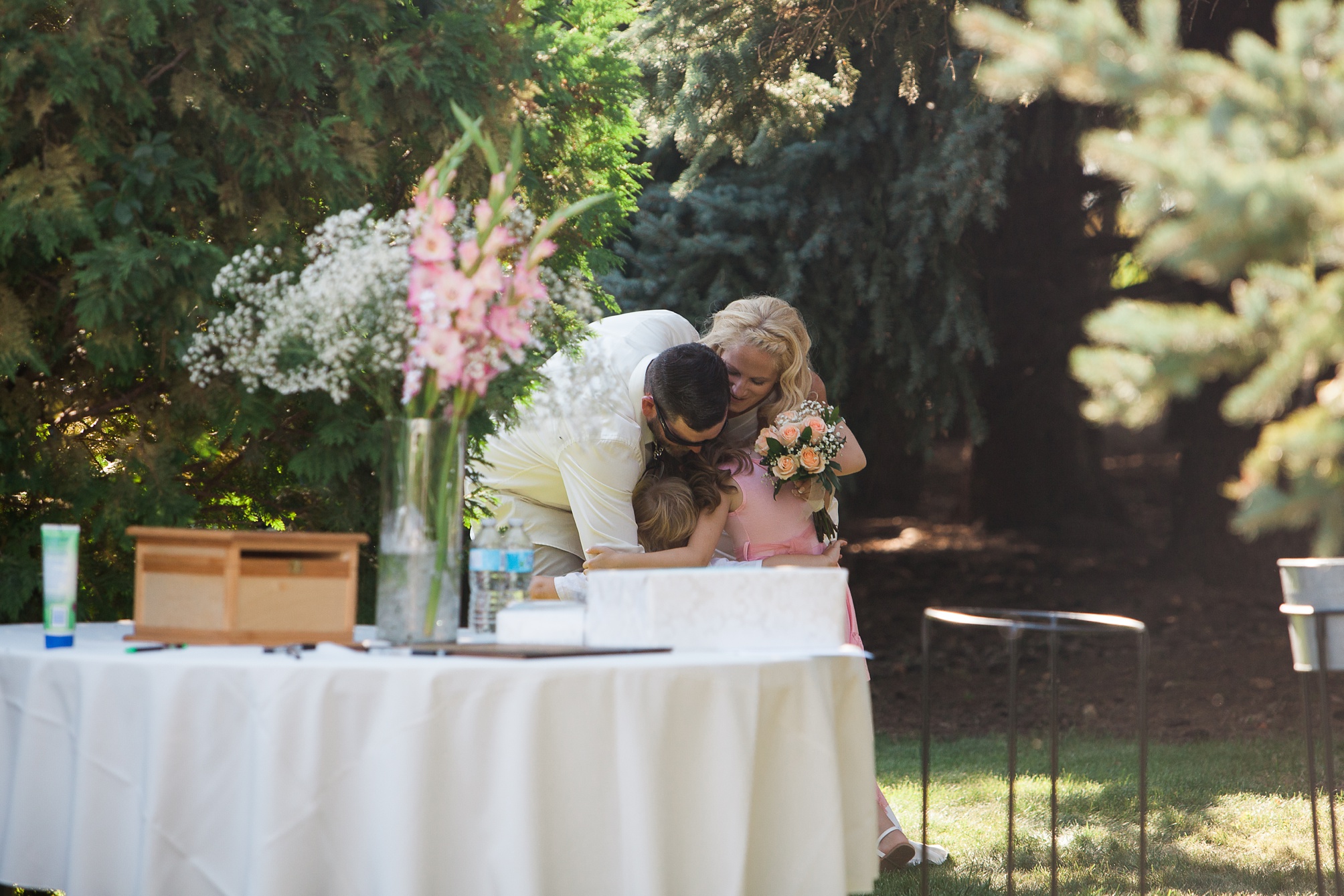 Sweet family moment at this Casual pink and white backyard wedding 
