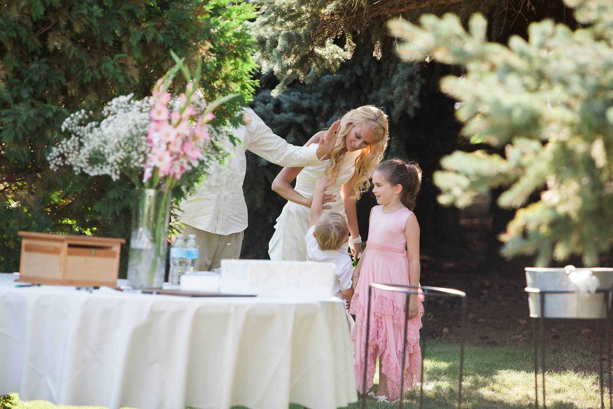 High fives for the family at this Casual pink and white backyard wedding 