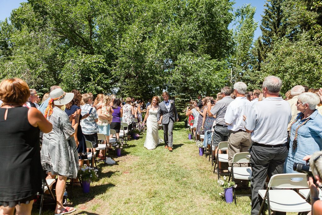 Outdoor farmyard ceremony vows Getting ready Southern Alberta wedding photographer Kinsey Holt