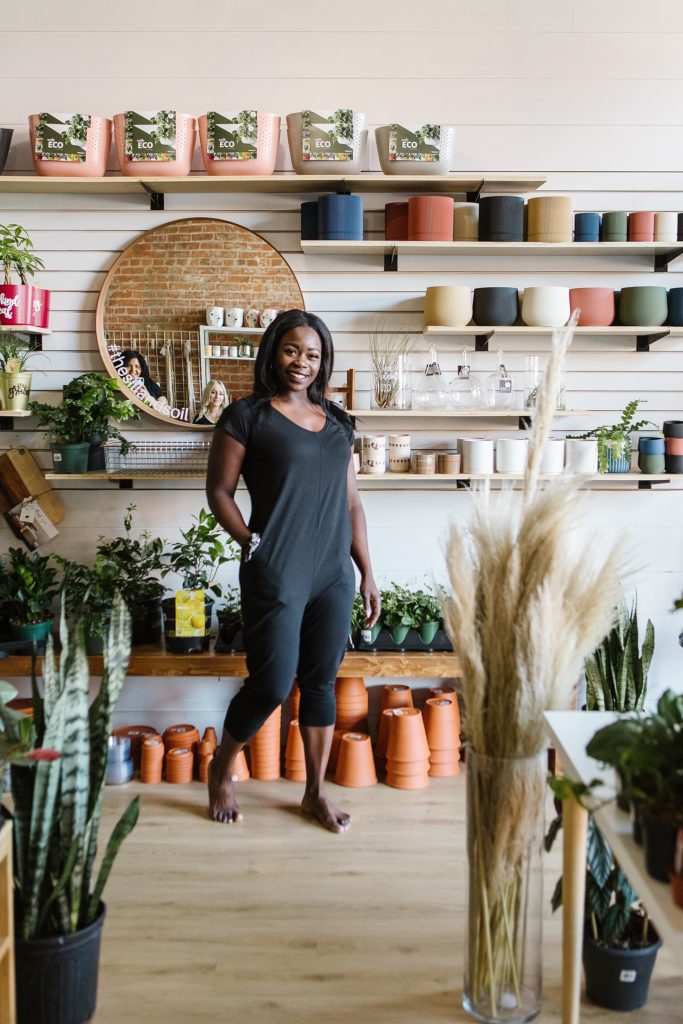 Model wearing romper in plant store