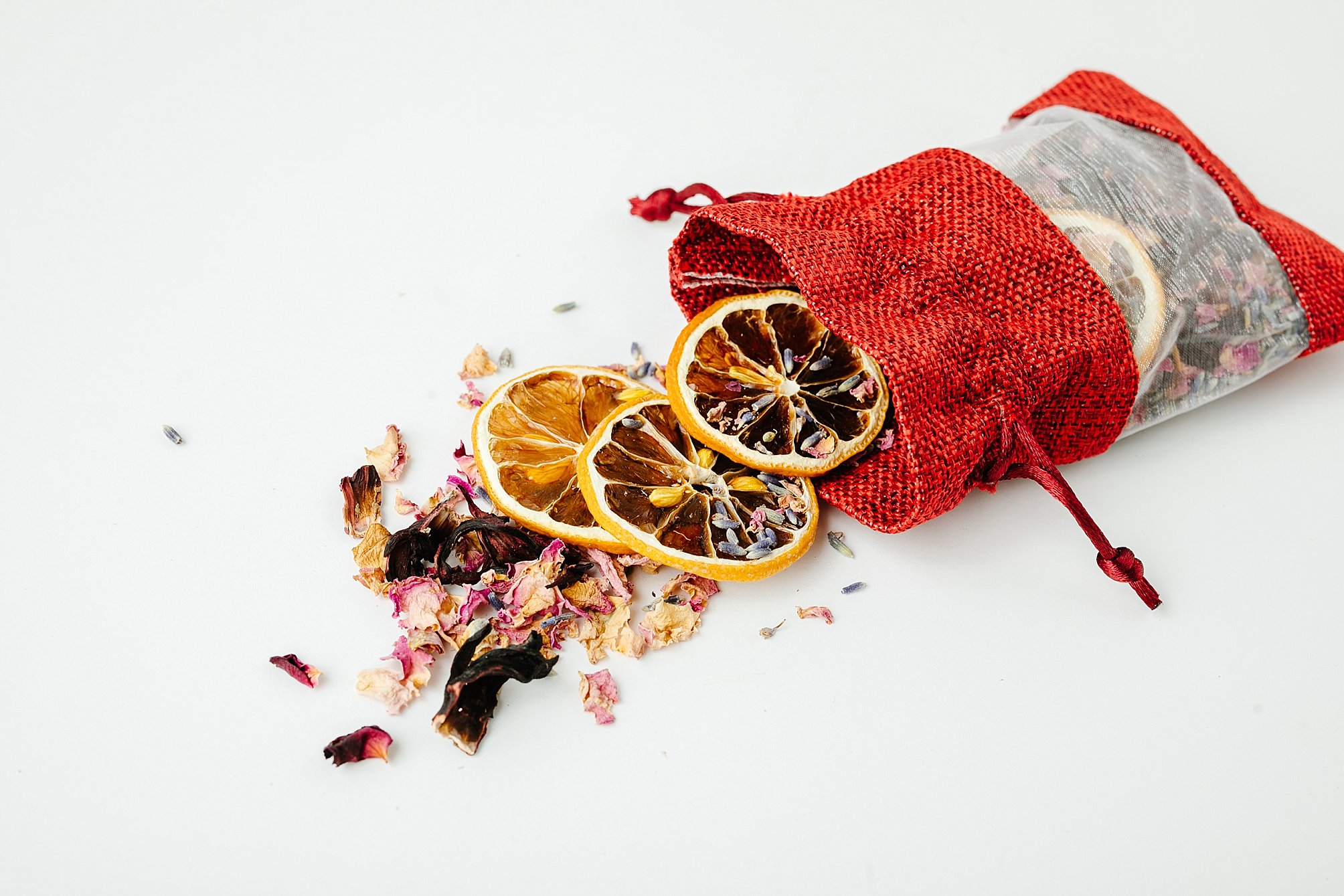 Bag with dried fruit and flowers spilling out.