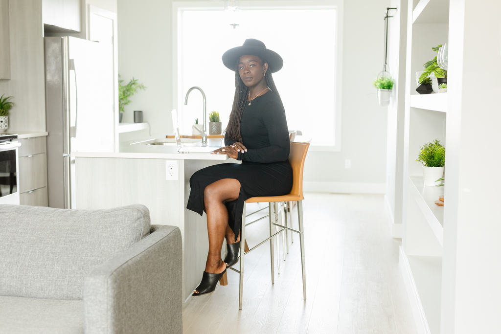 Clothing boutique owner sitting at a counter, photographed by Lethbridge brand photographer Kinsey Holt