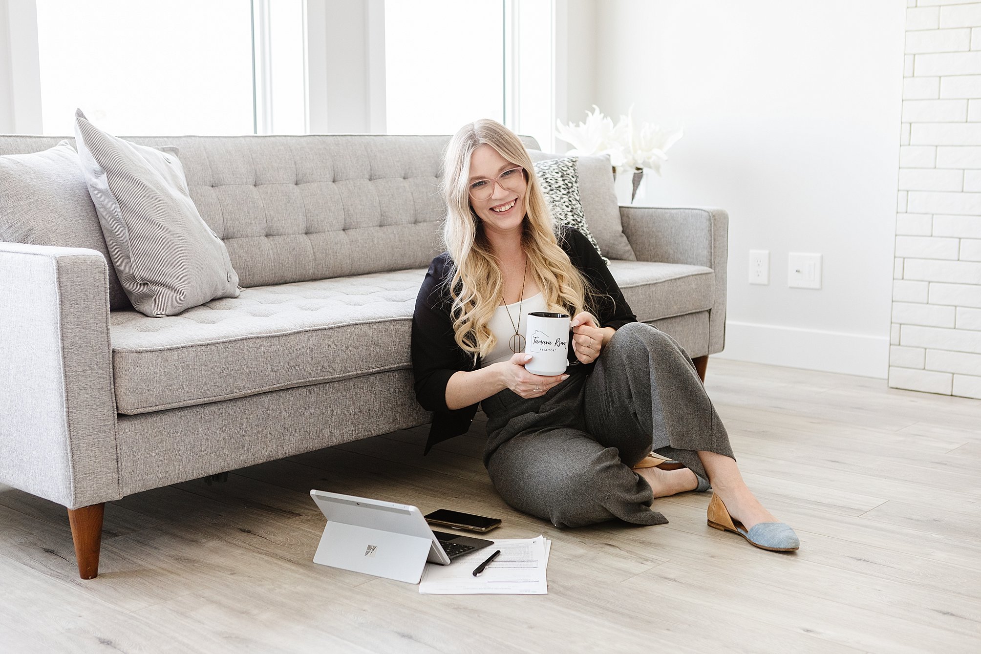 Realtor brand photography shows realtor sitting on floor working, photographed by Kinsey Holt