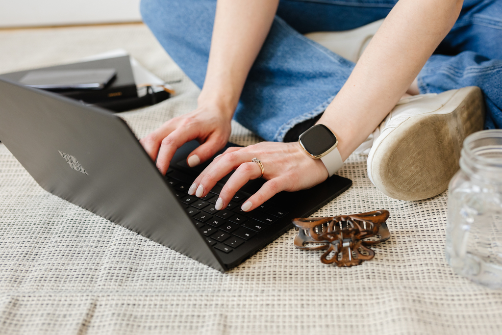 Flatlay of hands typing on laptop