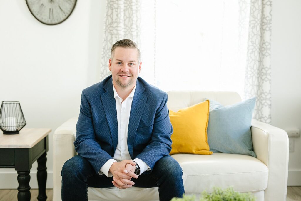 Realtor sitting on couch, photographed by Lethbridge realtor photographer Kinsey Holt