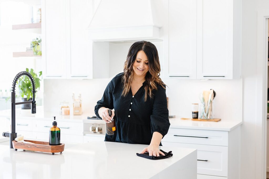 Woman wiping kitchen counters.