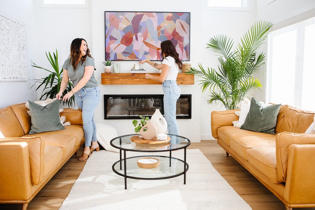 Two women staging a living room for their interior designer brand photoshoot - Lethbridge brand photography by Kinsey Holt