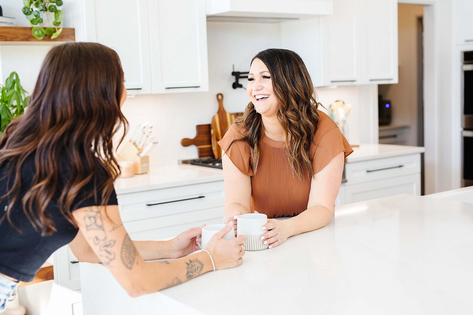 Two women laughing looking very comfortable on camera - Lethbridge brand photography by Kinsey Holt