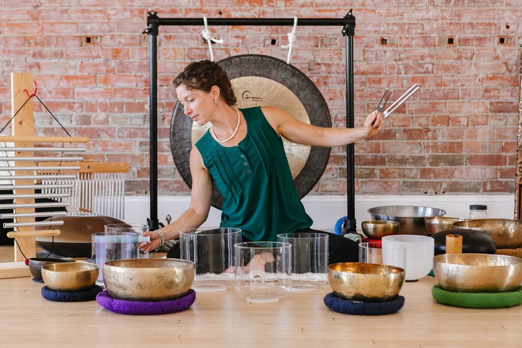 Sound therapist playing bowls, captured by Lethbridge wellness photographer Kinsey Holt