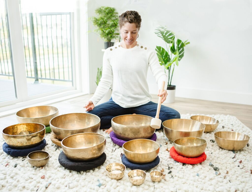 Sound therapist playing bowls, captured by Lethbridge wellness photographer Kinsey Holt
