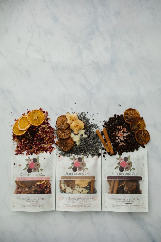 Three simmer mix pouches with dried botanical ingredients spilling out. Shot by Kinsey Holt Photography for Simmer and Co in Lethbridge Alberta.